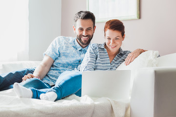 Young couple watching content on the laptop