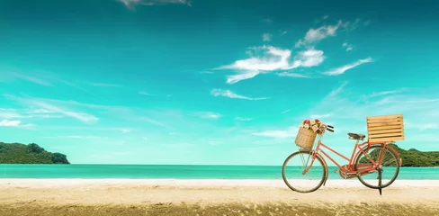 Poster Red vintage bicycle on white sand beach over blue sea and clear blue sky background, spring or summer holiday vacation concept,vintage style. © tapui