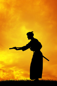 Man with katana at sunset