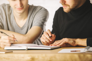 Fototapeta premium Focused boys doing paperwork