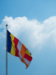 Buddhist flag against the sky