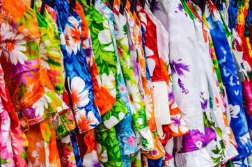 Closeup of different colored pattern fabrics or dresses on display in store