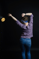 young pretty woman dancing, happy girl dancing on dark background
