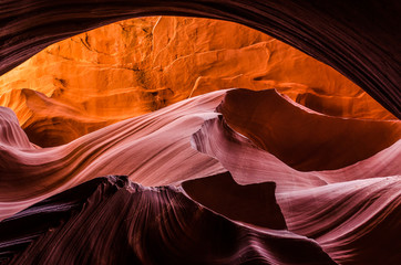 Pink peach wave shapes photographed at slots canyons sunset in Arizona.