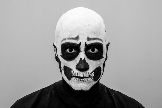 Beautiful man with creative make-up for the Halloween party