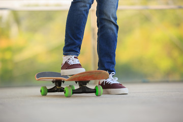 Fototapeta na wymiar skateboarder legs skateboarding at skatepark