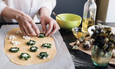 Foto op Canvas Step by step the chef prepares ravioli with ricotta cheese, yolks quail eggs and spinach with spices. The chef prepares the filling on the dough © Mikhaylovskiy 