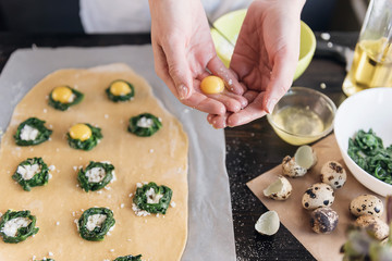 Step by step the chef prepares ravioli with ricotta cheese, yolks quail eggs and spinach with spices. The chef prepares the filling on the dough
