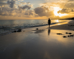 woman walking on beach at sunrise Jamaica