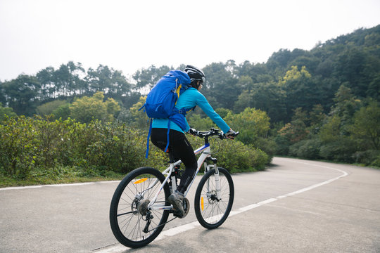 cyclist cycling mountain bike on foggy forest trail