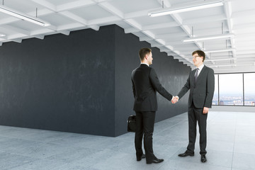 Men shaking hands in interior