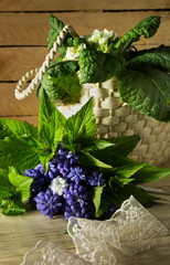 Bouquet of flowers and a wicker basket on a wooden background 3