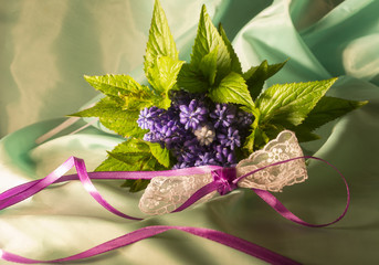 Bouquet of lilac flowers and lace bow