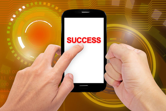 Isolated hand holding a phone with message "SUCCESS" on the abstract background.(Business and Competition concept)
