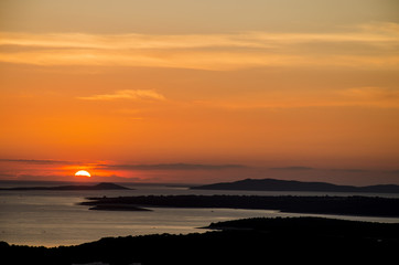 the sky is on fire, scenic seascape of the sunset over the sea, whit black silhouette of islands