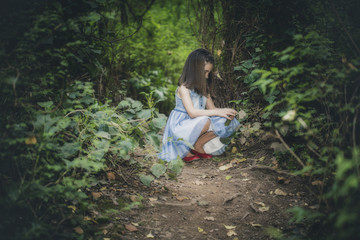 Girl picks flowers in the forest