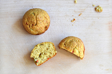 Fresh muffins on wooden pad.Salty appetizer cut in half.Healthy diet
