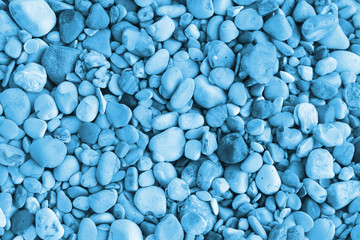 Fototapeta na wymiar Naturally water polished blue pebbles background