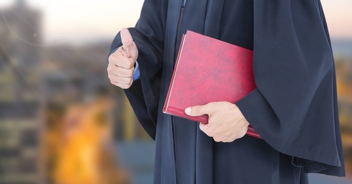 Judge holding book in front of city - Powered by Adobe