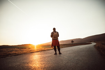 Skater man in sunset, rear view