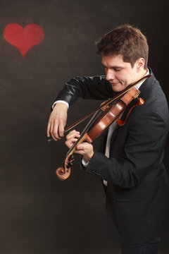 Man man dressed elegantly playing violin