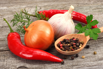 spices onion, garlic and chili pepper on old wood background