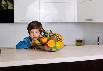 Little boy with a bowl of fresh fruits