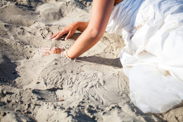 Bride in her dress on the beach