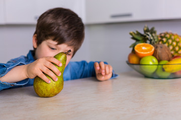 Fototapeta premium Little boy with a bowl of fresh fruits