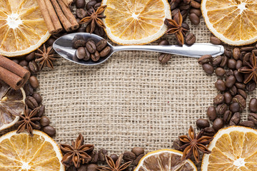 orange slices with coffee beans and spices on canvas background