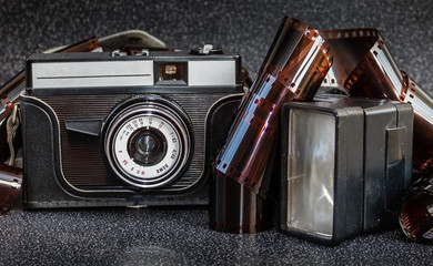 An old camera,flash and film tape