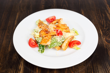 Plate with fresh caesar salad with chicken