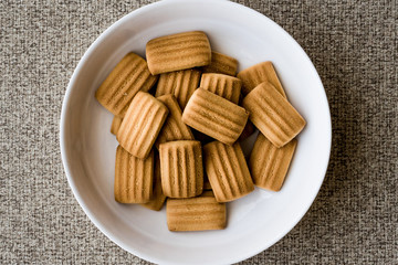 Baby biscuit in white bowl.