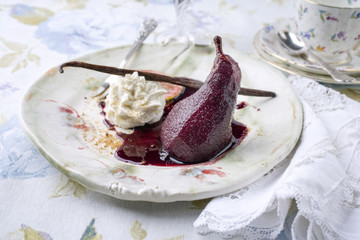 Traditional French poached Pear as close-up on a Plate