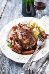 Coq au Vin with Vegetable and Potato puree in Burgundy Sauce as close-up on a plate