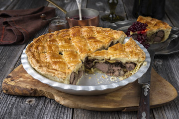Vanison Pie with Cranbeery Relish as close-up in a backing dish