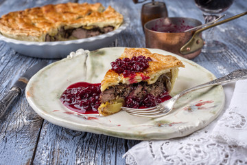 Wildkuchen mit Preiselbeeren Relish als close-up auf Teller