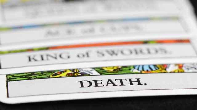 Focus rack / focus pull of tarot card deck. Death card in focus at the end