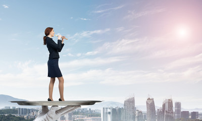 Attractive businesswoman on metal tray playing fife against cityscape background