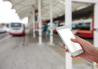 Hand with mobile in the bus station