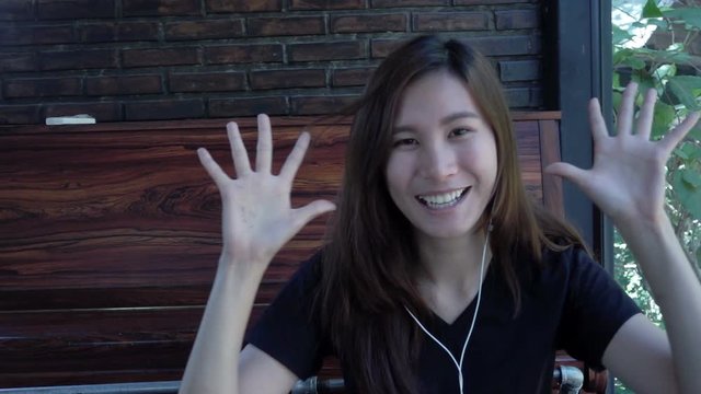 Happy young woman smiling to camera in cafe