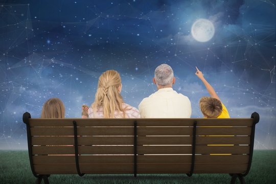 Composite image of family watching the moon