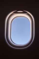 Blue sky in airplane window