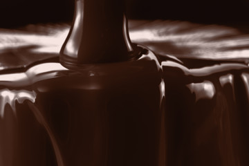 Pouring liquid hot chocolate closeup. Cooking dessert.