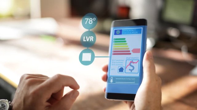 A Homeowner Uses A Home Controlling and Security Application on the smartphone 