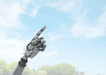 Android Robot hand pointing with bright sky background