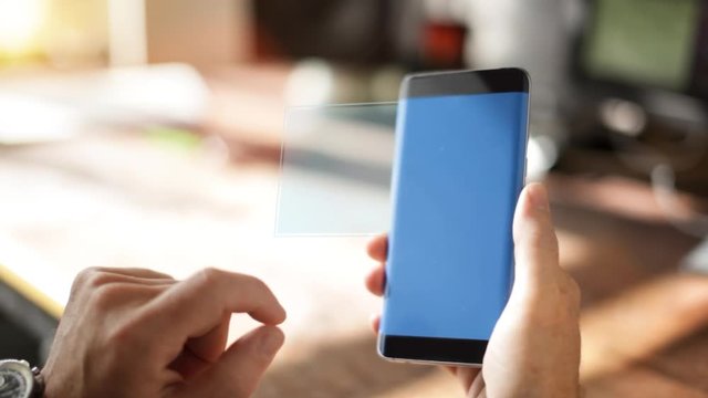 A Homeowner Uses A Home Controlling and Security Application on the smartphone 