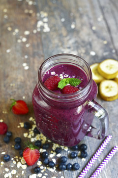 Blueberry smoothie in a mason jar .