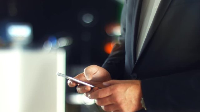 Using a Smartphone, sliding the screen and taping, close up shot with soft bokeh