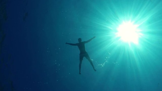 A man is diving in the blue sea - 5